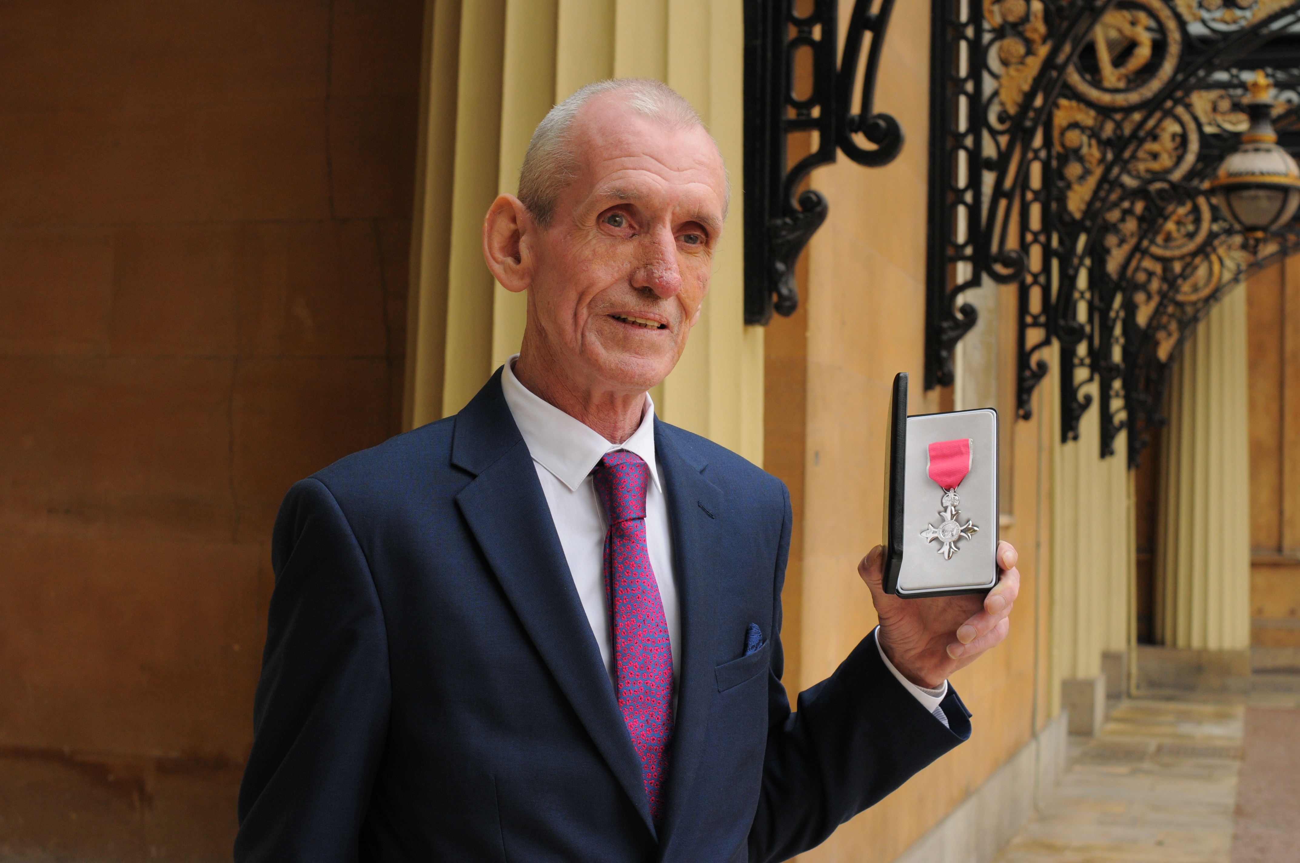 Dennis Rogers with his MBE medal